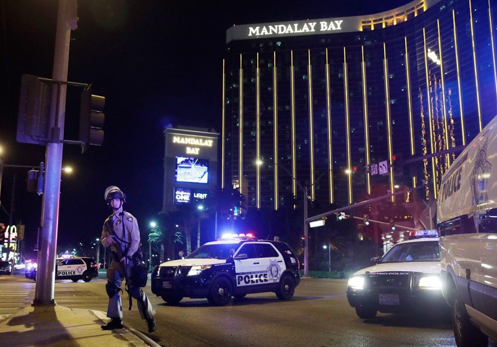 Las Vegas Shooting Police officers stand along the Las Vegas Strip the Mandalay Bay resort and casino during a shooting near the casino, Sunday, Oct. 1, 2017, in Las Vegas. (AP Photo/John Locher)
